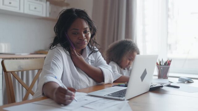 Career and family, african american women working remotely from home, child near. Contemporary work-from-home mom and successful multitasking business woman, parenting and job, online work for moms