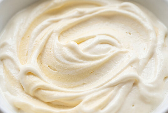 Close up view of soft creamy vanilla ice cream texture with undulating waves and swirls