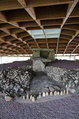 Naklejka premium Dolmen of dombate megalithic burial tomb protected by modern structure