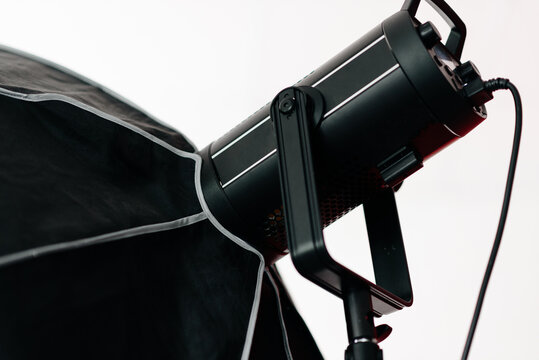black lighting device in photo studio, monoblock with octobox on it, professional studio light