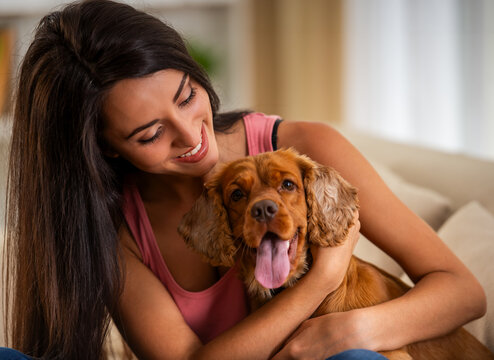 Happy Woman Hugging Dog.