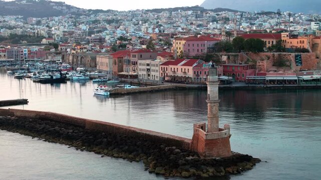  View of Chania with the amazing lighthouse, mosque, venetian shipyards, Crete, Greece.Waves crashing on lighthouse, Beautiful Greece and best scenic places - panorama