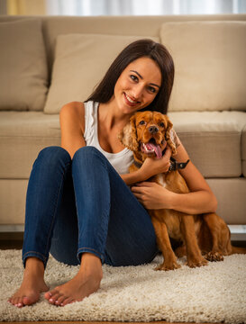 Happy Woman Hugging Puppy.