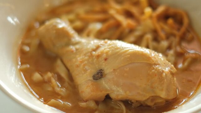 Chicken leg in broth with noodles, Khao Soi: Northern Thai Curry Noodle Soup 
