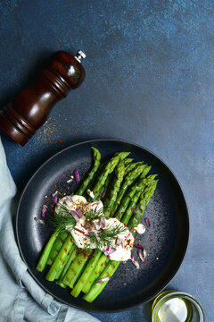 Grilled asparagus stalks with garlic sauce. Top view with copy space.