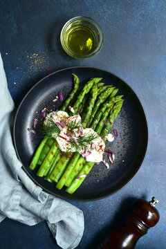 Grilled asparagus stalks with garlic sauce. Top view with copy space.