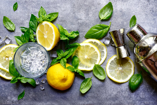 Ingredients fo making cold summer lemon and basil cocktail. Top view with copy space.