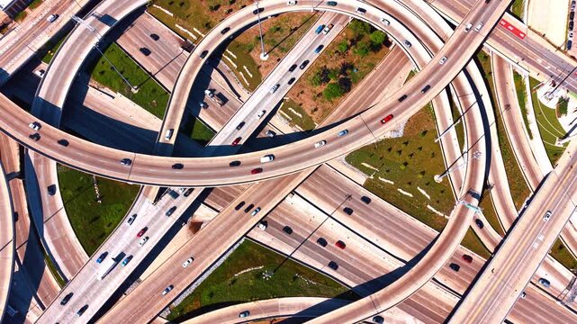 Lots of cars run by the highways and loops of lively intersection. Descend over Jane Byrne Interchange in Chicago, Illinois, USA.