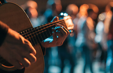 Obraz premium Musician Strumming Acoustic Guitar Live Indoor Event Hands Motion — Natural Wood Body Dark Fretboard, Blurred Crowd Arms Raised Warm Amber Cool Blue Stage Bokeh — Community Worship