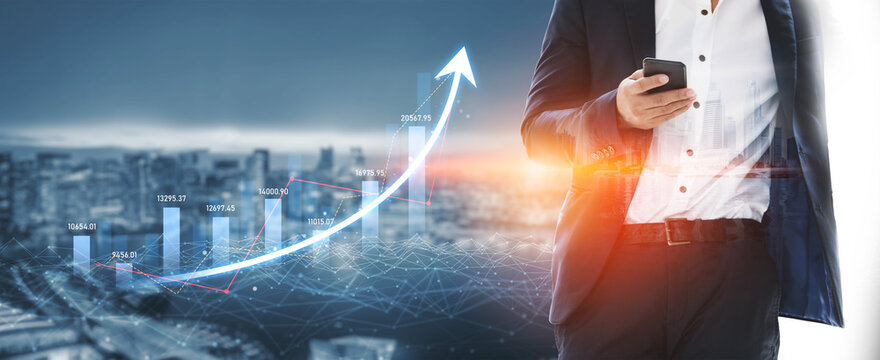 Businessman in a suit holds a smartphone with an overlay of a financial growth graph and a city skyline at sunset, symbolizing investment and technology advancements. Scalp