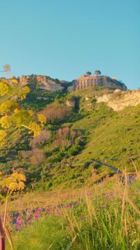 Gerace city seen from below at sunset over the valley