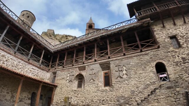 David Gareji monastery presenting its ancient rock-cut caves in Georgia. Stone structures. And historical architecture within the dry landscape