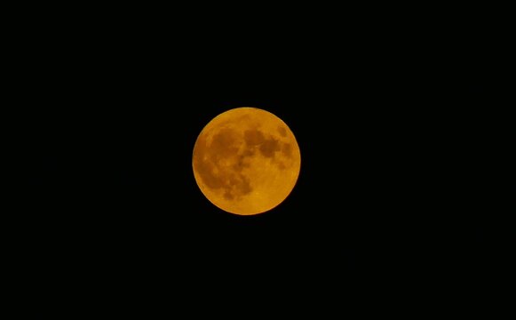 Red big full moon surface shine bright on a dark sky, solar, lunar phase, astronomy, space background