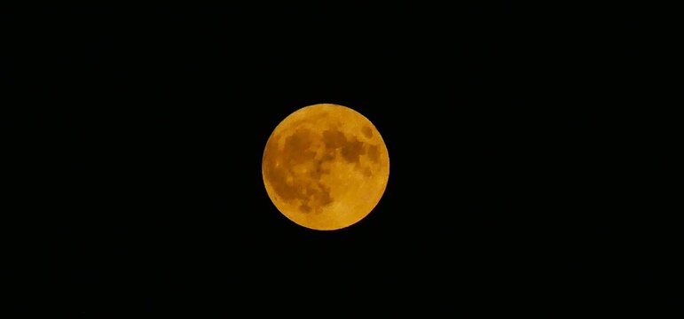 Red big full moon surface shine bright on a dark sky, solar, lunar phase, astronomy, space background