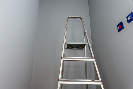 Ladder in renovated room for painting walls