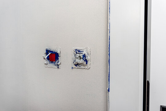 Wall undergoing renovation with blue painter's tape