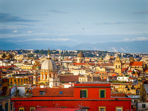 Aerial drone view of Naples old town panorama and roofs of Naples residential buildings, scenic cityscape of historic center and iconic volcano view in Italy