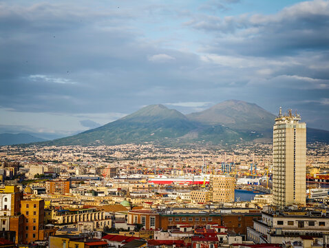 Aerial drone view of Naples old town panorama with Mount Vesuvius in background, scenic cityscape of historic center and iconic volcano view in Italy