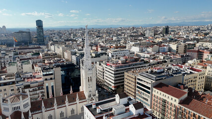 Obraz premium Wide aerial panorama featuring Basílica de la Concepción de Nuestra Señora surrounded by the dense urban landscape of Madrid, Spain