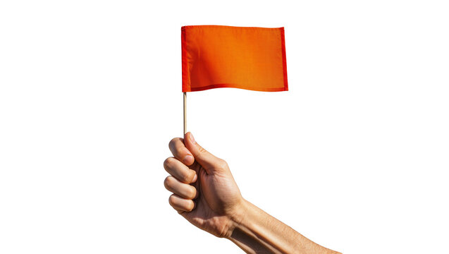 Isolated close-up of a human hand holding a small vibrant orange flag on a wooden stick