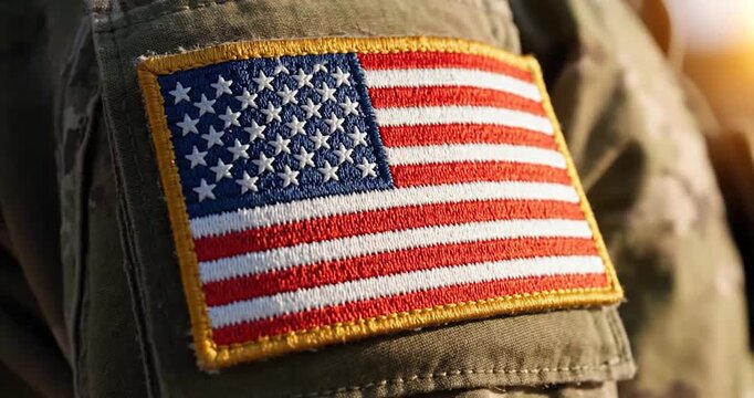 Close-up of American flag patch on a military camouflage uniform sleeve