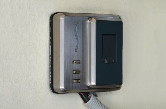 Modern Metallic Wall Mounted Electronic Access Control Unit Side Angle Perspective Closeup Shot for Smart Building Security Access System Door Entrance Device Equipment Concept