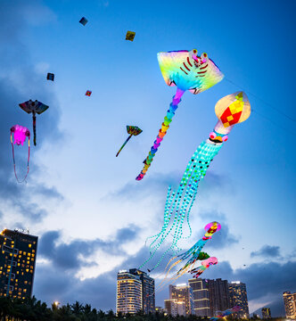 Kite flyers along Da Nang Beach,show off their skills,on the sands at dusk.