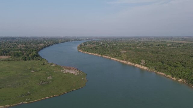 Stunning high altitude perspective flying above Tuxpan River in Mexico that meanders through a dense, verdant forest and countryside, showcasing the natural beauty of the expansive rural landscape