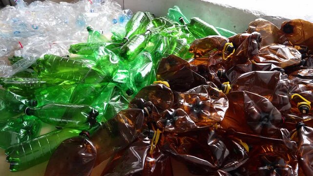 Empty crushed clear green brown plastic bottles
