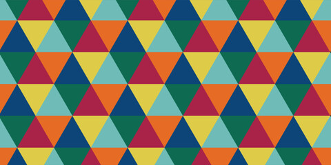 Fototapeta premium Seamless abstract geometric pattern with colorful triangles. Retro mosaic background with orange, blue, yellow, and red repeating triangular shapes vector illustration.