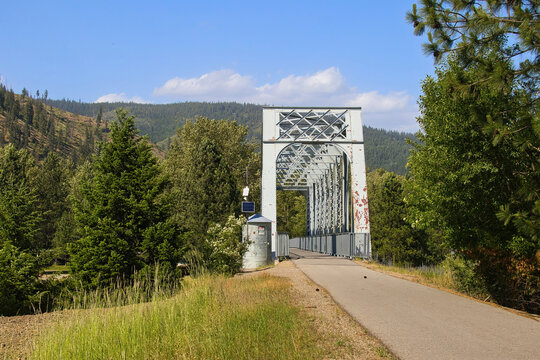 The view on a sunny summer day approaching on old railroad trestle along the Trail of the Coeur d&rsquo;Alenes in the forest near Kellogg, Idaho.