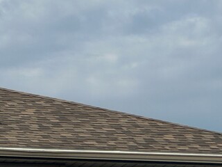 Fototapeta premium Shingles on a Residential Asphalt Roof Exterior Detail Close-Up View