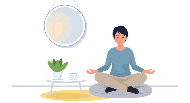 A woman sits cross-legged on a cushion, practicing meditation in a minimalist living room with a potted plant, coffee cup, and wall art.