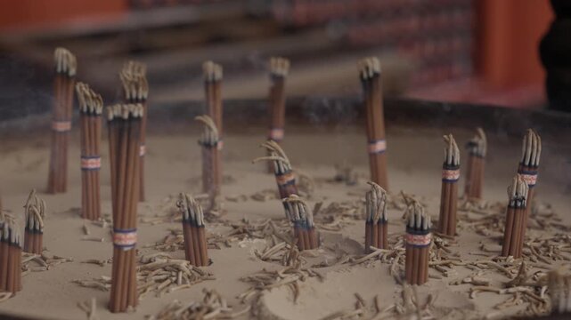 Bundles of incense sticks placed upright in sand burner at Buddhist temple Japan