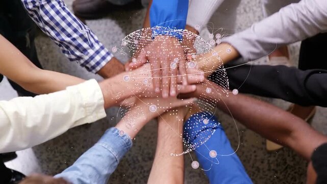 Hands reaching in, team stacking hands and pressing while globe particles orbit, lifting for unity