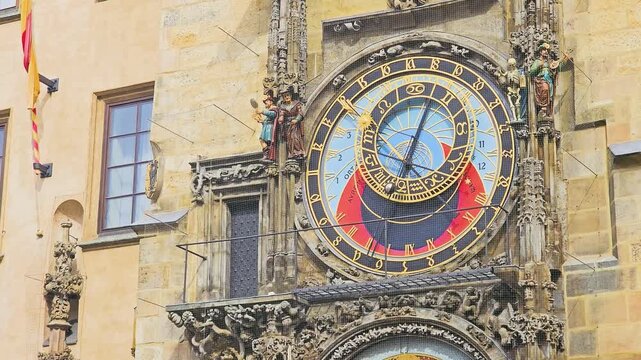 Close-up of the Prague Astronomical Clock in Old Town Square, showing colorful medieval dial, golden Roman numerals, carved statues, Gothic stone details, and historic Czech architecture.