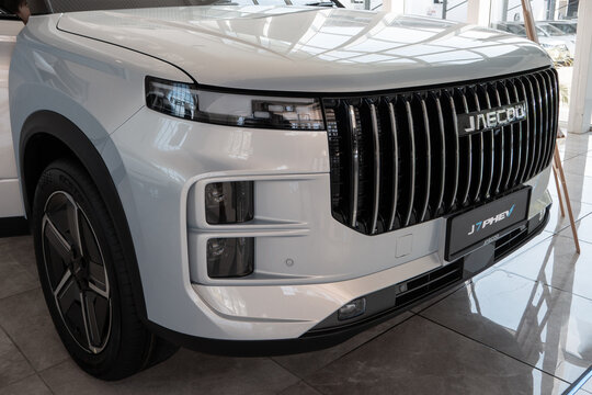 Close-up of the jaecoo text logo on the front grille of a white suv