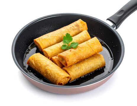 A frying pan contains several fried cylindrical food items, garnished with herbs