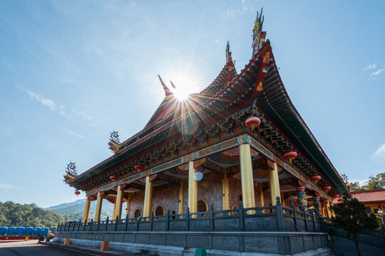Traditional chinese temple architecture with sunburst through roof