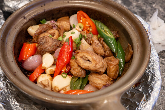 Chinese food stir-fry in clay pot with chili and garlic