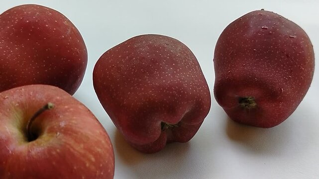 Whole fresh apple isolated on a white background with detailed texture and vivid color, symbolizing wellness, natural food, antioxidant-rich fruit, healthy diet, and premium agricultural products. Ide