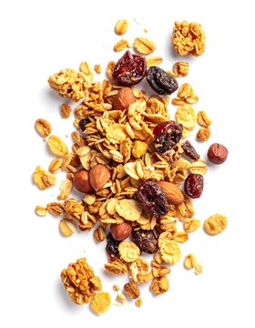 A pile of assorted, crunchy breakfast ingredients on a white background