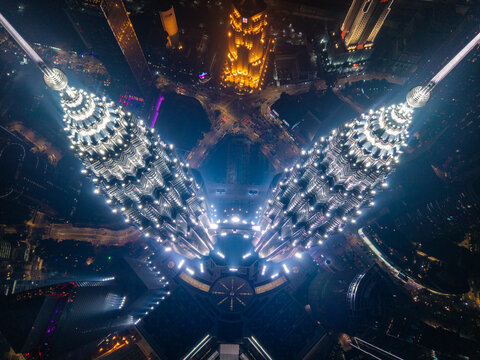 Petronas towers illuminating kuala lumpur urban cityscape at night