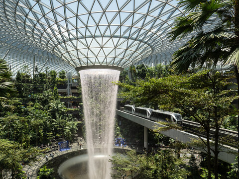 Iconic Rain Vortex waterfall and indoor garden at Jewel Changi Airport, Singapore.