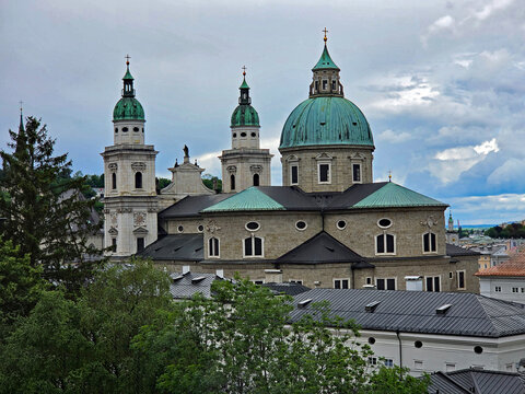 Salzburg Cathedral in Salzburg, Austria from footpath to Hohensalzburg Fortress on rainy overcast summer afternoon.