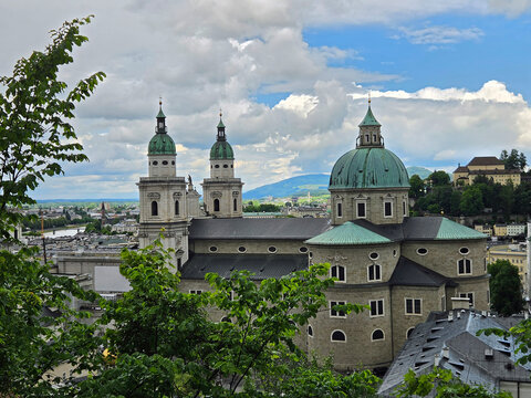 Salzburg Cathedral in Salzburg, Austria from footpath to Hohensalzburg Fortress on rainy overcast summer afternoon.