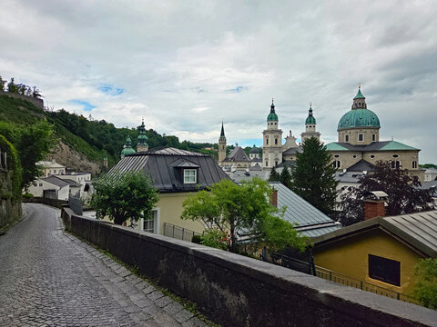 Salzburg Cathedral in Salzburg, Austria from footpath to Hohensalzburg Fortress on rainy overcast summer afternoon.