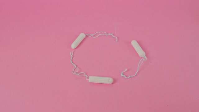 Stop motion animation of tampons forming cycle loop on pink