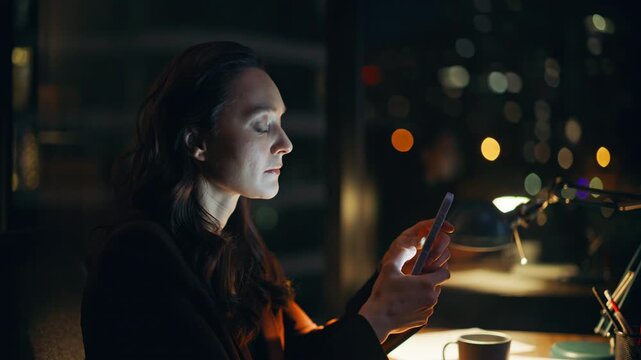 Late worker reading sms mobile phone under lamp light nighttime office closeup