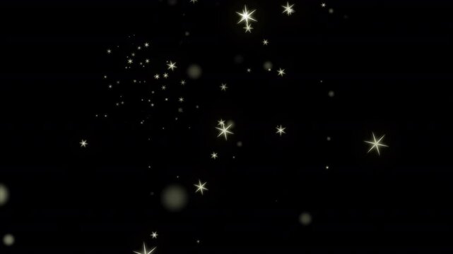Golden bokeh particles form a glowing yellow light heart against black background.